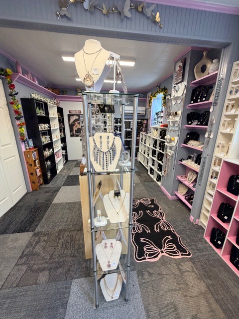 Glass display of curated necklaces