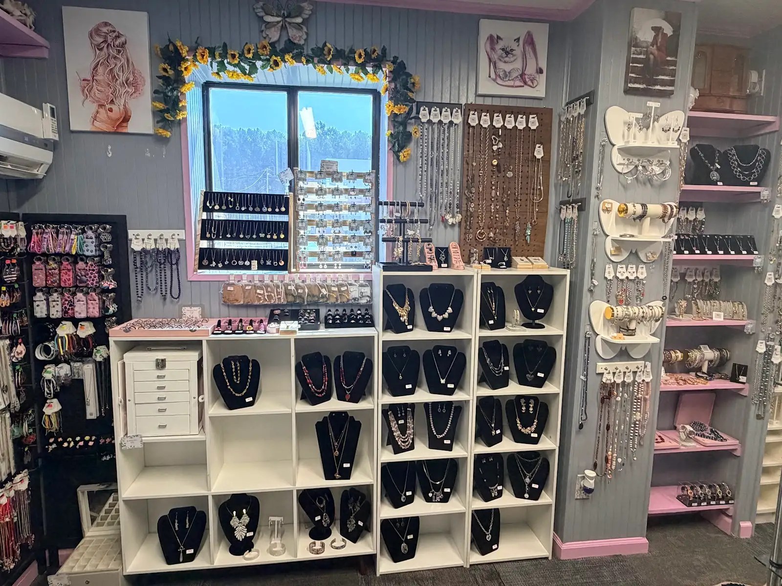 Necklace and earring wall with pink shelving