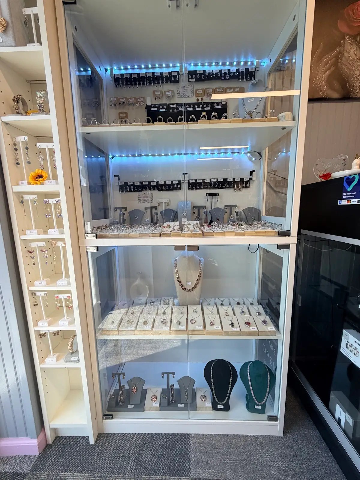 Lit jewelry case with earrings, necklaces and pendants