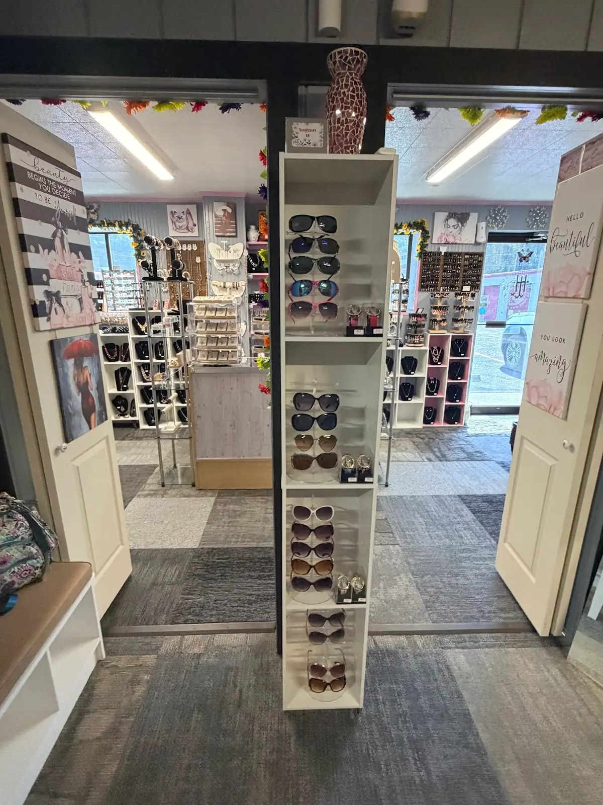 Entryway with sunglasses tower and jewelry beyond