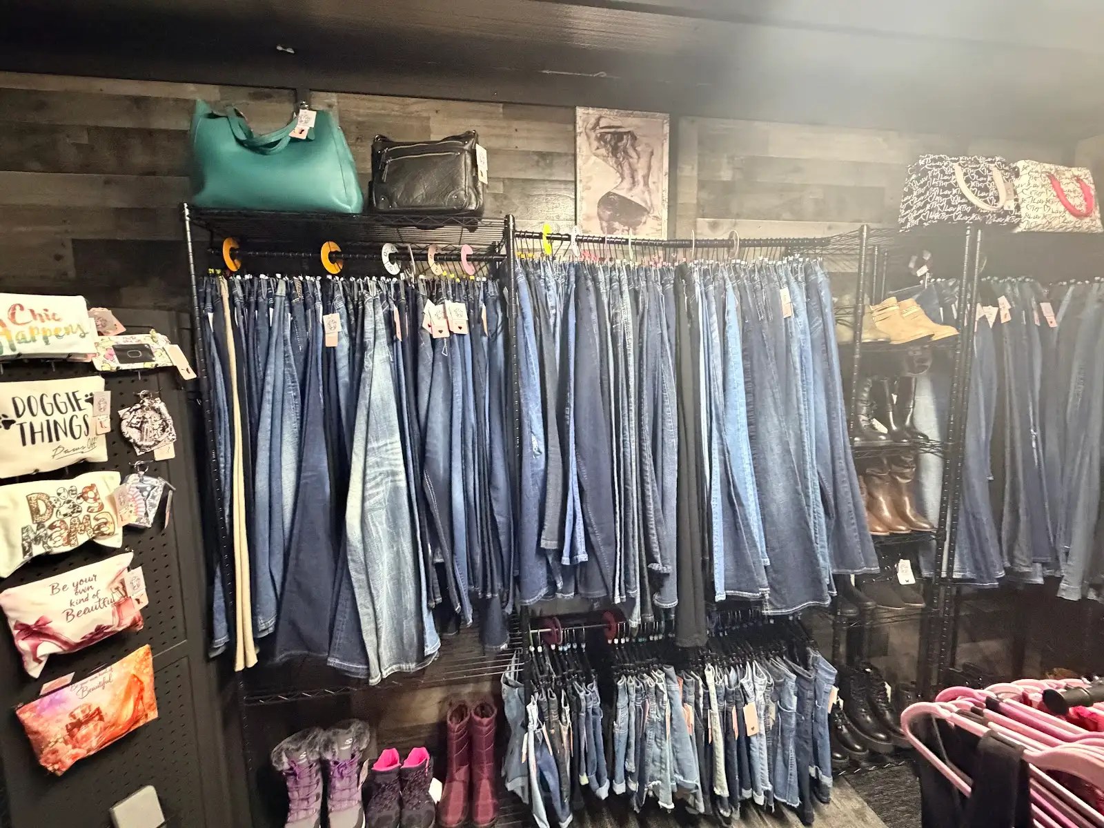 Wall of denim jeans with handbags above